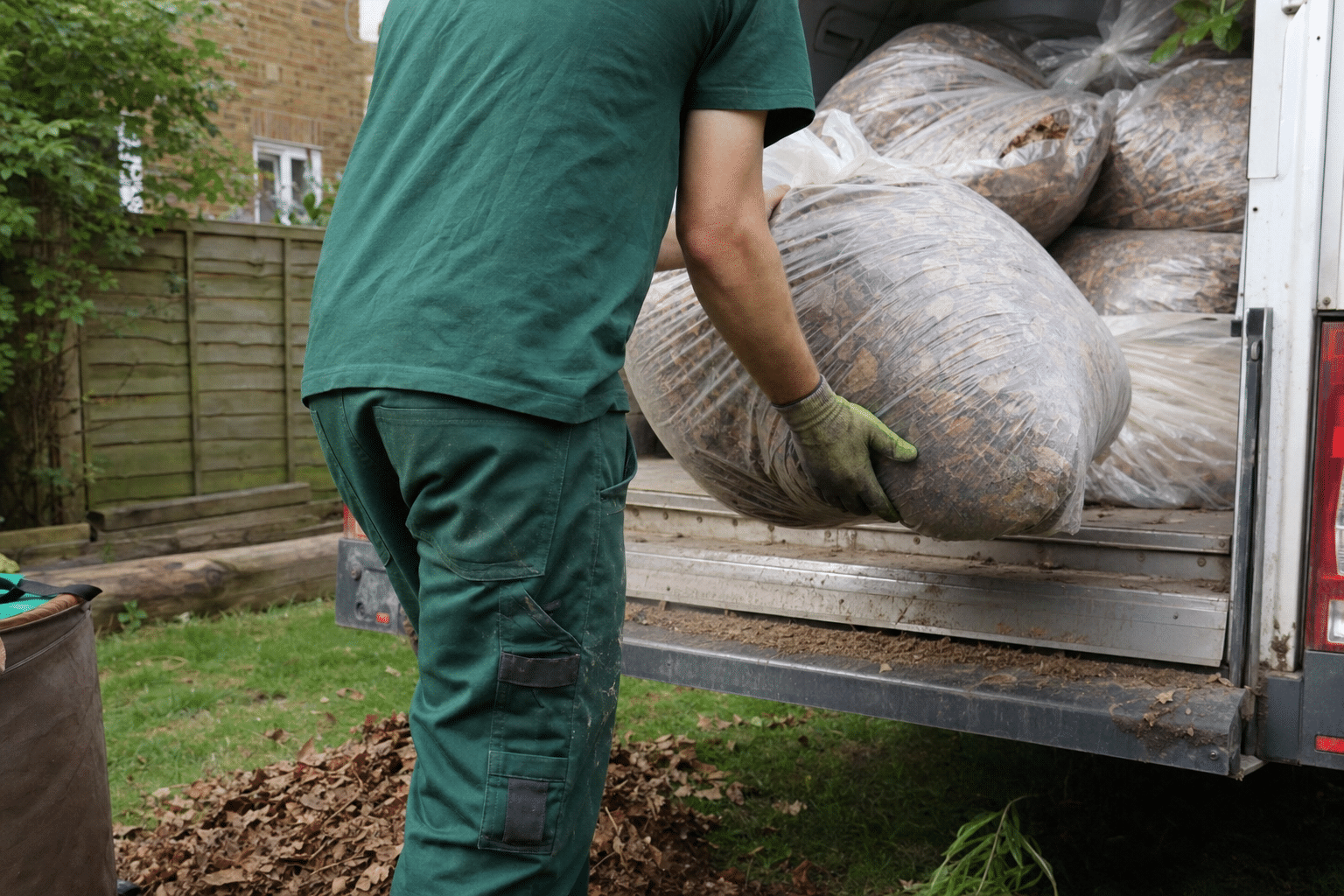 bagged leaves being loaded into the Urban Gardeners van outside a terraced house in New Cross SE14