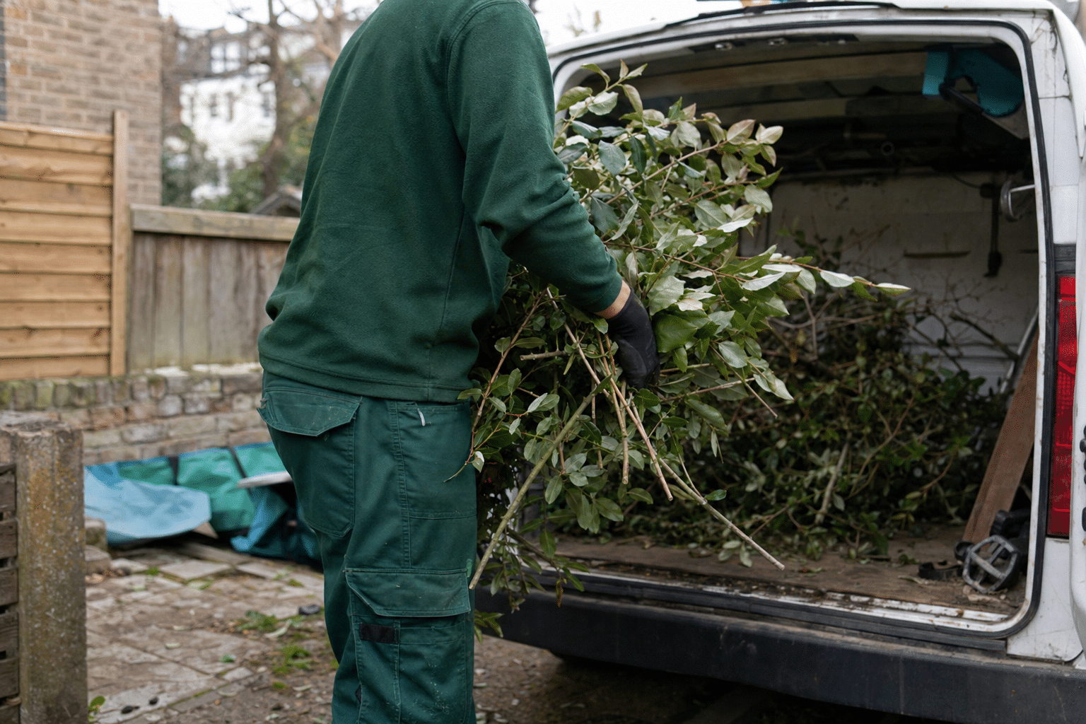 Urban Gardeners team loading hedge cuttings into the van on a terraced street in Brockley SE4